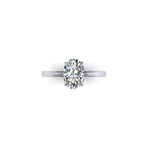 Hidden Halo with Tapered Shank Featuring Oval Brilliant This ring features an oval brilliant center stone set in a tapered pinched solitaire shank with a diamond basket that elegantly cradles the center stone.