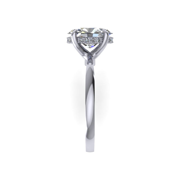 Hidden Halo with Tapered Shank Featuring Oval Brilliant This ring features an oval brilliant center stone set in a tapered pinched solitaire shank with a diamond basket that elegantly cradles the center stone.