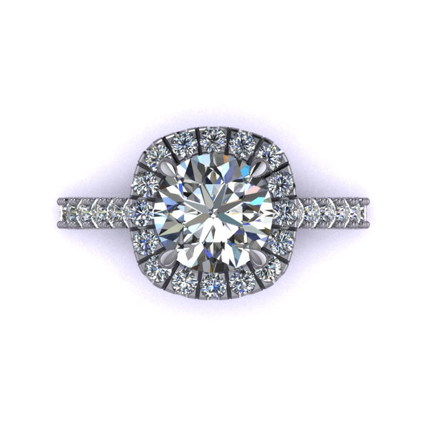 This rendering features a round brilliant center stone set in a soft cushion halo with a diamond basket, diamond bridge, and an elegant cathedral style shank. The diamonds are set in a delicate but durable micro-prong setting style to maximize the brilliance of the diamonds. The height of the halo is medium to high, which helps create the look for more prominence and brilliance, showcasing the center stone best. 